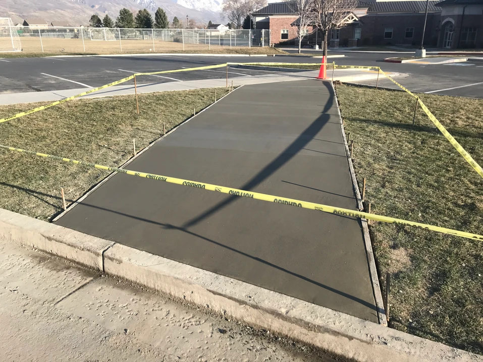 Fresh-Concrete-Pour-Fenced-Area-Walkway-Near-Parking-Lot